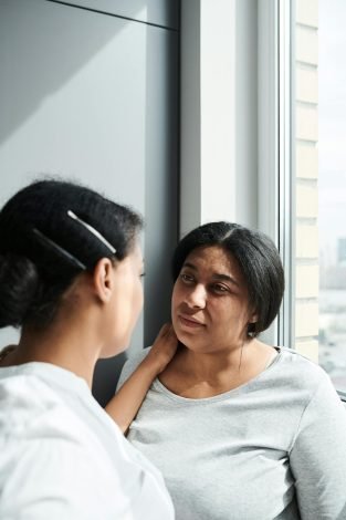 A loving couple shares an intimate moment by the window, reflecting love and connection.